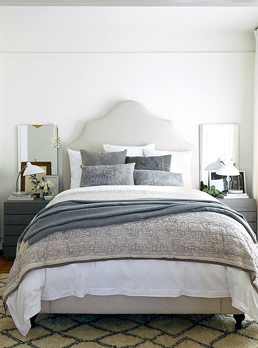 The muted palette, as much as the padded headboard and plush bedding, all but ensures a great night’s sleep. Design by One Kings Lane Interior Design; photo by Laura Resen.
